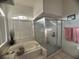 Bathroom with a shower, bathtub and a window at 1530 Davenport Dr, New Port Richey, FL 34655