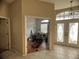 Entryway with double doors and a view into a cluttered room at 1530 Davenport Dr, New Port Richey, FL 34655