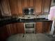 Kitchen with wooden cabinets and stainless steel appliances at 1530 Davenport Dr, New Port Richey, FL 34655