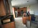 Kitchen with wood cabinets and granite countertops at 1530 Davenport Dr, New Port Richey, FL 34655