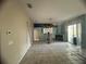 Living room with tiled floors and sliding glass doors at 1530 Davenport Dr, New Port Richey, FL 34655