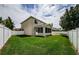 Spacious backyard with a screened patio and grassy area at 1553 Regal Mist Loop, Trinity, FL 34655