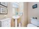 Clean bathroom with pedestal sink, toilet and updated fixtures at 1553 Regal Mist Loop, Trinity, FL 34655