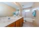 Double vanity bathroom with shower/tub combo and window at 1553 Regal Mist Loop, Trinity, FL 34655