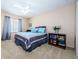 Bright bedroom with blue and gray bedding and built-in shelving at 1553 Regal Mist Loop, Trinity, FL 34655