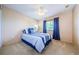 Comfortable bedroom with ceiling fan and blue bedding at 1553 Regal Mist Loop, Trinity, FL 34655