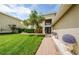 House exterior showcasing walkway, landscaping, and a lush lawn at 1553 Regal Mist Loop, Trinity, FL 34655
