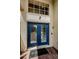 Blue double front door with sidelights and a welcoming entryway at 1553 Regal Mist Loop, Trinity, FL 34655