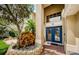 Two-story house with a blue double front door and landscaping at 1553 Regal Mist Loop, Trinity, FL 34655