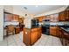 Kitchen boasts dark wood cabinets, granite counters, and stainless steel appliances at 1553 Regal Mist Loop, Trinity, FL 34655