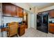 Kitchen with built-in desk, dark wood cabinets, and granite countertops at 1553 Regal Mist Loop, Trinity, FL 34655