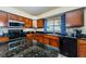 Kitchen with granite island, stainless steel appliances, and ample counter space at 1553 Regal Mist Loop, Trinity, FL 34655