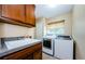 Laundry room with washer, dryer, sink, and ample cabinet space at 1553 Regal Mist Loop, Trinity, FL 34655