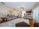 Open living room with hardwood floors, neutral colors, and a view to the kitchen at 1553 Regal Mist Loop, Trinity, FL 34655