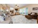 Bright living room features hardwood floors, comfy seating, and access to a patio at 1553 Regal Mist Loop, Trinity, FL 34655