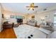 Spacious living room with hardwood floors, comfortable seating, and large TV at 1553 Regal Mist Loop, Trinity, FL 34655