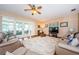 Spacious living room with hardwood floors, comfy seating, and access to lanai at 1553 Regal Mist Loop, Trinity, FL 34655