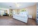 Main bedroom with plush carpet, ceiling fan, and ensuite bathroom at 1553 Regal Mist Loop, Trinity, FL 34655