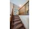 Upstairs hallway with carpeted staircase and wooden railing at 1553 Regal Mist Loop, Trinity, FL 34655
