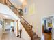 Elegant wooden staircase with carpeted steps and wooden railings at 1553 Regal Mist Loop, Trinity, FL 34655