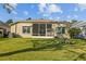 Well-maintained backyard featuring a screened porch and lush green lawn at 15555 Martinmeadow Dr, Lithia, FL 33547