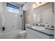 Well-lit bathroom features a bathtub-shower combination and a vanity with ample counter space at 15555 Martinmeadow Dr, Lithia, FL 33547