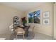 Cozy breakfast nook with round table set for four, flooded with natural light and views of a beautiful outdoor scene at 15555 Martinmeadow Dr, Lithia, FL 33547