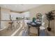 Well-lit breakfast nook showcasing a round table, seating for four, and proximity to a kitchen with a breakfast bar at 15555 Martinmeadow Dr, Lithia, FL 33547
