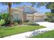 Two-story home boasts a 3-car garage and manicured landscaping, enhancing its curb appeal at 15555 Martinmeadow Dr, Lithia, FL 33547