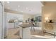 The kitchen area has white cabinets and access to an informal dining area at 15555 Martinmeadow Dr, Lithia, FL 33547