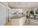 The kitchen area has white cabinets and access to an informal dining area at 15555 Martinmeadow Dr, Lithia, FL 33547