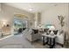 The living room features neutral colors, a ceiling fan and vaulted ceilings at 15555 Martinmeadow Dr, Lithia, FL 33547