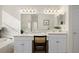 Spacious main bathroom features double sinks, a large mirror, and an open doorway with view to a shower at 15555 Martinmeadow Dr, Lithia, FL 33547