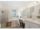 Serene main bathroom featuring double sinks, a soaking tub, separate shower, and plenty of natural light at 15555 Martinmeadow Dr, Lithia, FL 33547