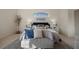 Comfortable main bedroom featuring a stylish chaise lounge and serene decor with a bright accent wall at 15555 Martinmeadow Dr, Lithia, FL 33547