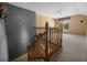 Carpeted staircase and open, carpeted room features two-tone walls, vaulted ceiling, and large window for plenty of natural light at 15555 Martinmeadow Dr, Lithia, FL 33547