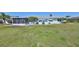 Single story home with a large backyard, screened patio, and lush lawn at 1806 Burlington Cir, Sun City Center, FL 33573