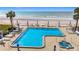 Stunning oceanfront pool and spa surrounded by lounge chairs and beach access at 18304 Gulf Blvd # 619, Redington Shores, FL 33708