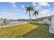 Landscaped backyard with canal views and lush grass at 1897 Clearwater Harbor Dr, Largo, FL 33770