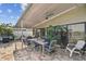 Covered patio features dining area and ceiling fan at 1897 Clearwater Harbor Dr, Largo, FL 33770