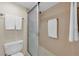 Clean and bright bathroom with a glass enclosed shower, neutral tile, and towel racks at 19029 Us Highway 19 N # 26-206, Clearwater, FL 33764