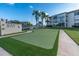 An expansive putting green sits adjacent to the condo building, inviting leisure and recreation in a scenic setting at 19029 Us Highway 19 N # 26-206, Clearwater, FL 33764