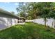 Landscaped backyard with grassy area and privacy fence at 1903 Oro Ct, Clearwater, FL 33764