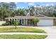Single-story house with attached garage and manicured lawn at 1903 Oro Ct, Clearwater, FL 33764