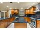 Island kitchen with granite countertops and stainless steel appliances at 1903 Oro Ct, Clearwater, FL 33764