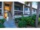 Exterior view of condo building with stairs and landscaping at 19505 Quesada Ave # O105, Port Charlotte, FL 33948