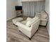 Living room featuring light beige upholstered furniture and wood-look flooring at 19505 Quesada Ave # O105, Port Charlotte, FL 33948
