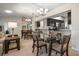Open concept dining area with glass-top table and kitchen views at 2112 Gulf View Blvd, Dunedin, FL 34698