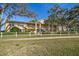 Condo building with white picket fence and mature trees at 2112 Gulf View Blvd, Dunedin, FL 34698