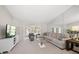 Living room with sectional sofa, large window, and TV at 2112 Gulf View Blvd, Dunedin, FL 34698